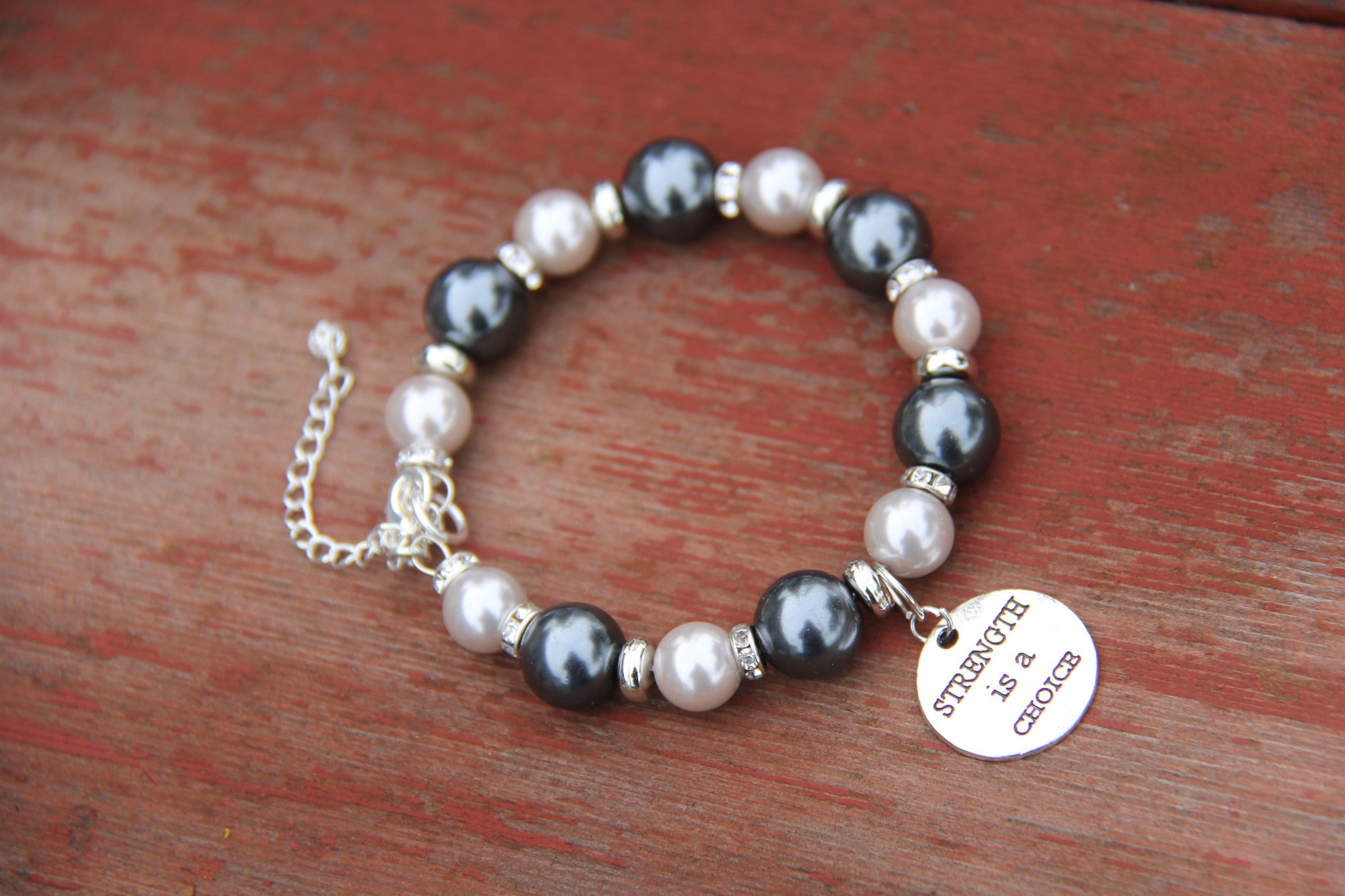Two shades of grey glass pearl beads with "Strength is a choice" silver charm